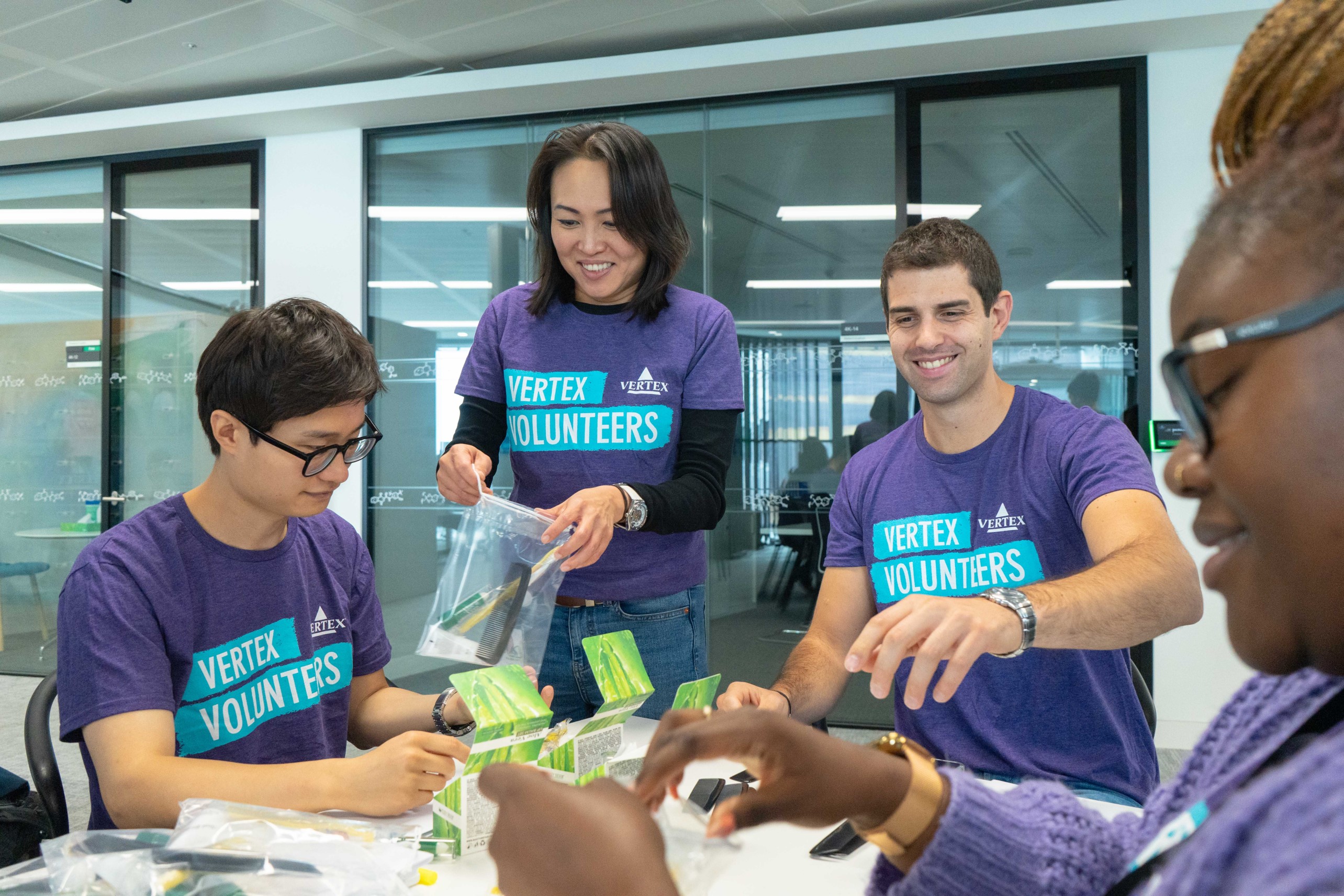 Four Vertex Volunteers packing items into bags