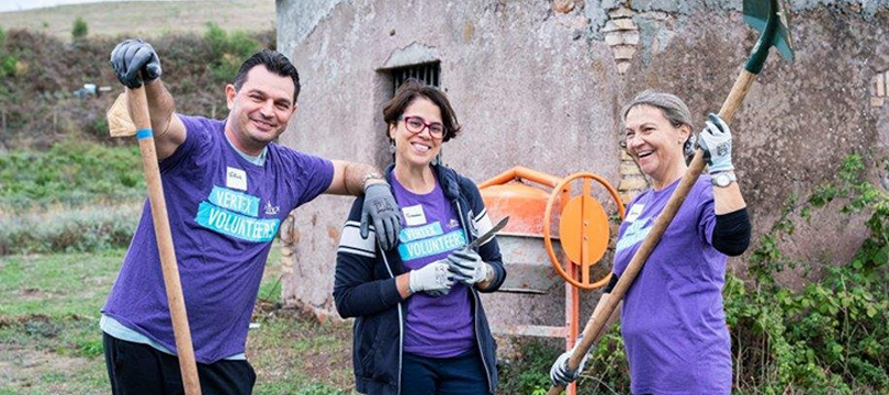 Three Vertex Volunteers working together outdoors